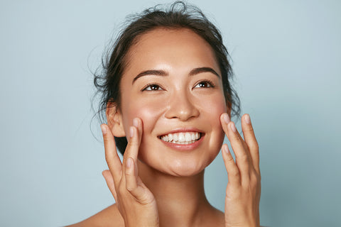 woman applying serum to face 