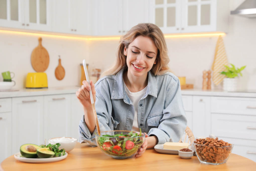 woman mixing salads