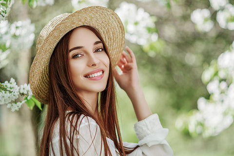 girl wearing straw hat smiling